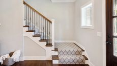 Light gray carpet on wooden stairs