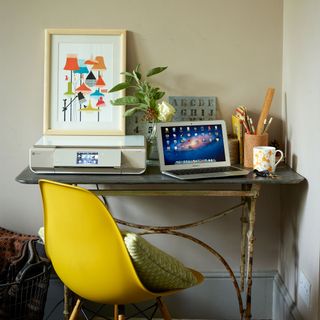 home office with desk and yellow chair with cushions