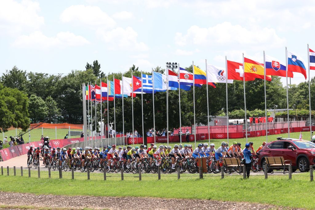Cyclists ride in the peloton behind the race director car at the start of the womens cycling road race of the Tokyo 2020 Olympic Games at Musashinonomori Park on the outskirts of Tokyo Japan on July 25 2021 Photo by MICHAEL STEELE POOL AFP Photo by MICHAEL STEELEPOOLAFP via Getty Images