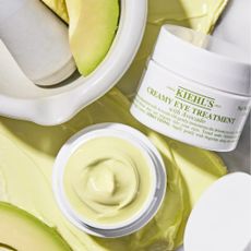 Photo of Kiehl's Creamy Eye Treatment next to avocado and avocado cream