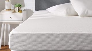 The Amazon Basics mattress on a bed