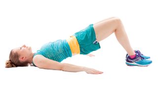 Woman wearing workout clothing doing a hip thrust move