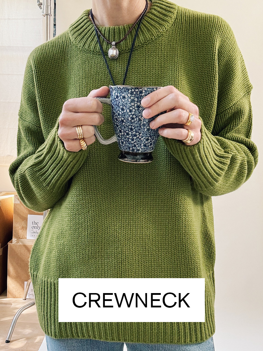 Woman in green crewneck sweater