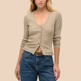 Flat lay image of woman wearing brown top and jeans 