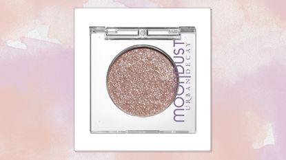 Image of Urban Decay&#039;s Moondust Eyeshadow in shade &#039;Space Cowboy&#039; on a pink watercolour background