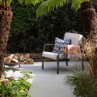 Patio with brick edging featuring an outdoor chair