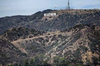 Photographer Olivia Hemaratanatorn captured this view of space shuttle Endeavour soaring over the famed Hollywood sign during its low flyover of Los Angeles on Sept. 21, 2012.
