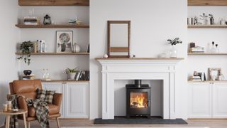 wood burning stove in white fireplace