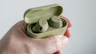 Jabra Elite 8 Active earbuds in case in hand.