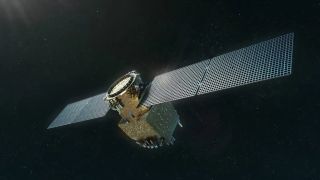 a cube-shaped spacecraft covered in gold foil with two large solar panels extending outward from it. stars can be seen behind it