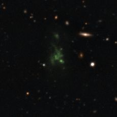 A giant green "space blob" - called the Lyman-alpha blob LAB-1 - is seen in this composite of two different images taken by the Very Large Telescope in Chile. The LAB-1 space blob is 300,000 light-years across, making it one of the largest known single ob