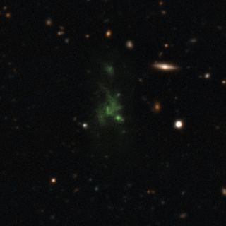 A giant green "space blob" - called the Lyman-alpha blob LAB-1 - is seen in this composite of two different images taken by the Very Large Telescope in Chile. The LAB-1 space blob is 300,000 light-years across, making it one of the largest known single objects in the universe.
