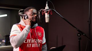 Daniel Kaluuya in the recording booth for All or Nothing: Arsenal, wearing an Arsenal jersey
