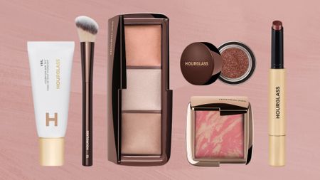 A collection of Hourglass makeup including the Veil Tint, No.15 Blush Brush, Ambient Lighting powder palette, Scattered Light eyeshadow, Airbrush Blush and Volumising Phantom Glossy Balm/ in a pink template