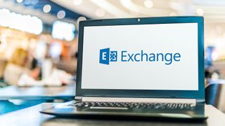 A laptop on a table with the Microsoft Exchange logo displayed