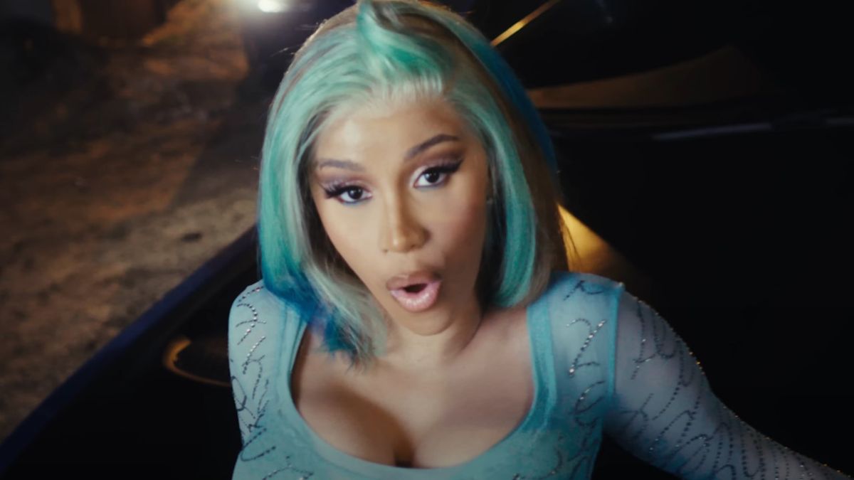 Cardi B with blue-green hair in music video for Point Me 2