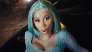 Cardi B with blue-green hair in music video for Point Me 2