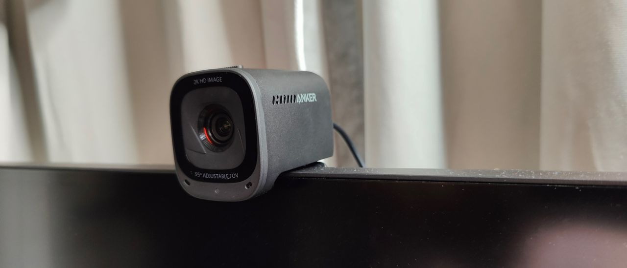 Angled photo of Anker PowerConf C200 webcam mounted on a monitor