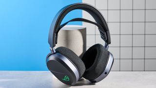 A black Asus ROG Pelta gaming headset with a detachable mic and RGB lighting