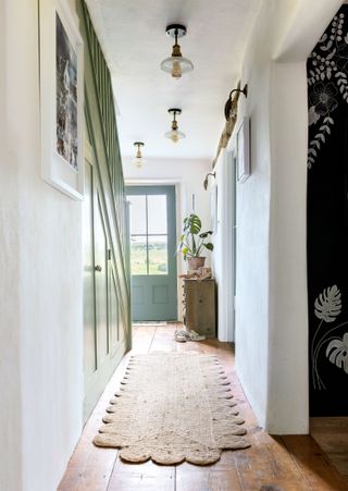 staircase hall and front door with scalloped jute rug