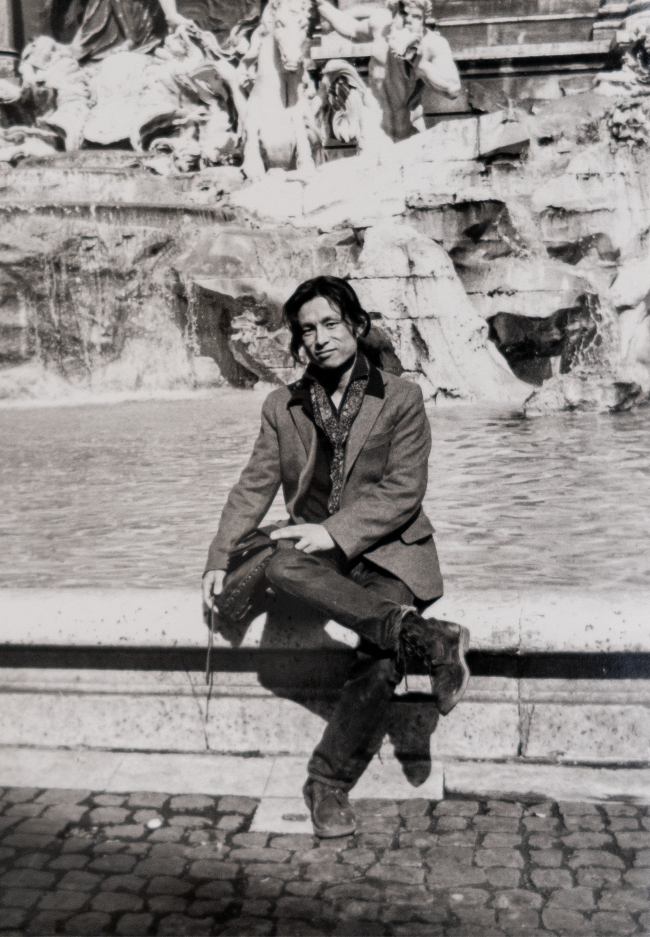 man by fountain in rome