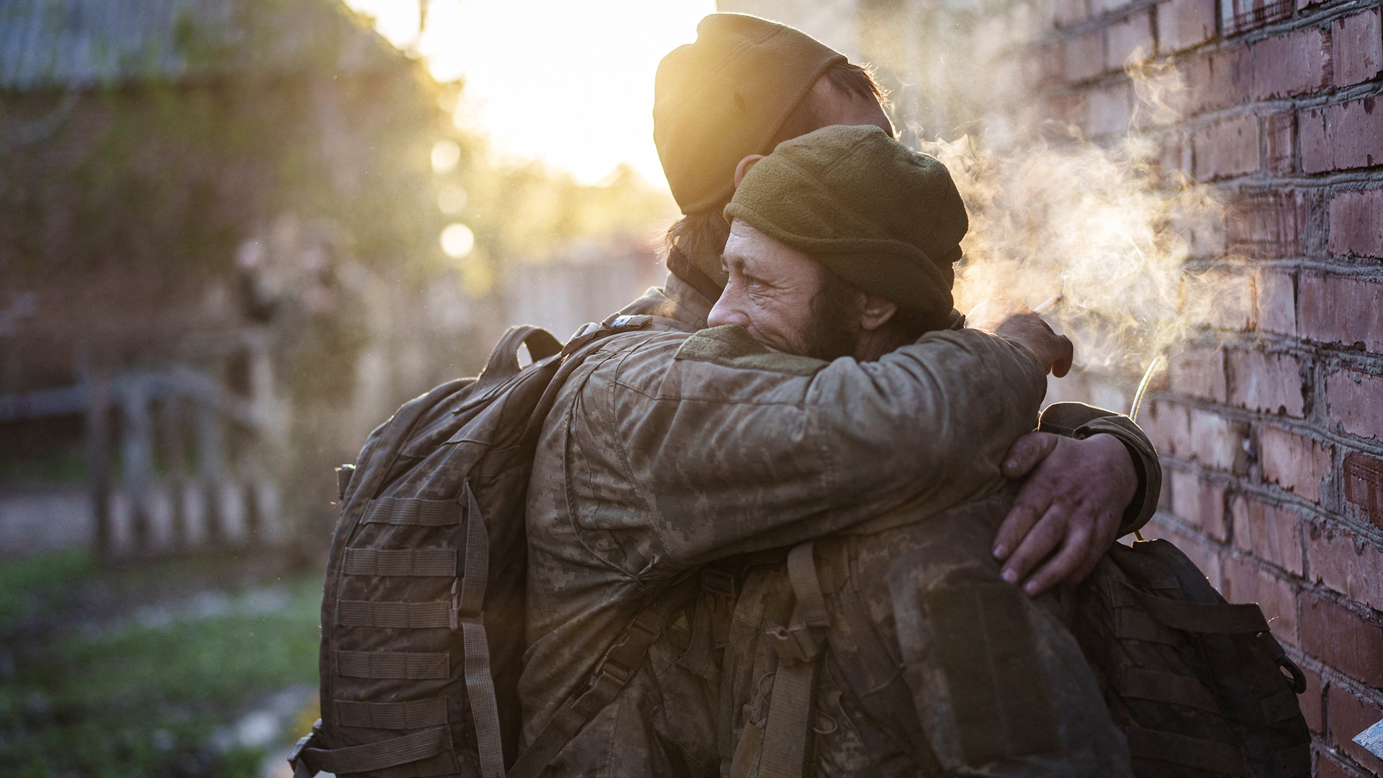 Servicemen of the 93rd Kholodnyi Yar Separate Mechanized Brigade of the Ukrainian Armed Forces embrace after returning from half a year positioned on the frontline, in Donetsk, Ukraine