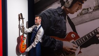 A selection of guitars owned and used by Noel Gallagher, including (l-r) an Epiphone EA-250, a Gibson Flying V and an Epiphone Les Paul Standard electric guitar, go on view at Sotheby's on September 09, 2024 in London, England