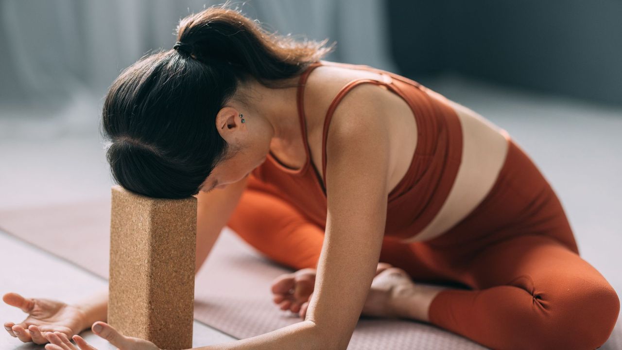 Morning yoga: A woman practicing yoga at home with blocks