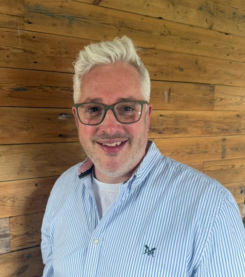 An expert headshot of Alex Main, Director at Main