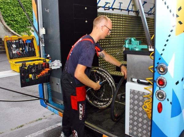 Kris Withington tends to the spare wheels after the stage.