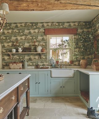 kitchen with patterned wallpaper and blue cabinetry