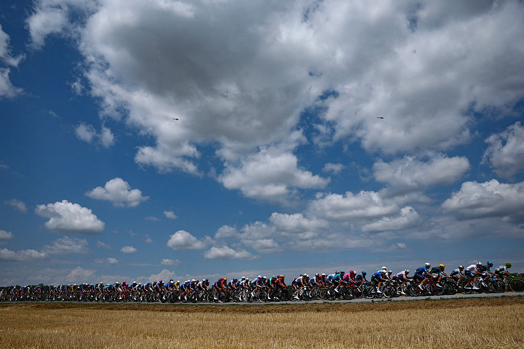 The pack of riders (peloton) cycles during the 13th stage of the 113th edition of the Tour de France cycling race, 205,8 km between Dole and Belfort in eastern France, on July 17, 2026. (Photo by Anne-Christine POUJOULAT / AFP)