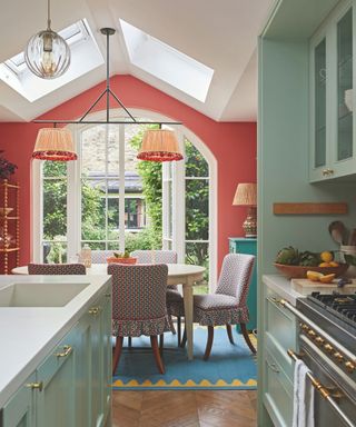 kitchen with green cabinetry and orange walls