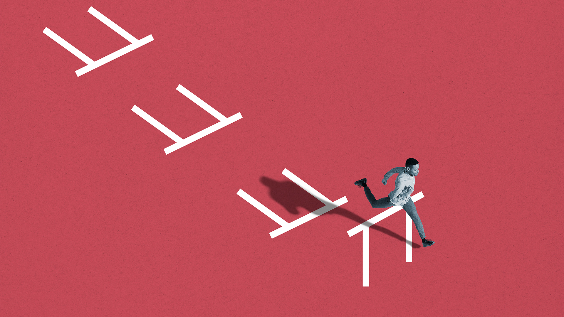 Man jumping over a hurdle with three fallen hurdles behind him.