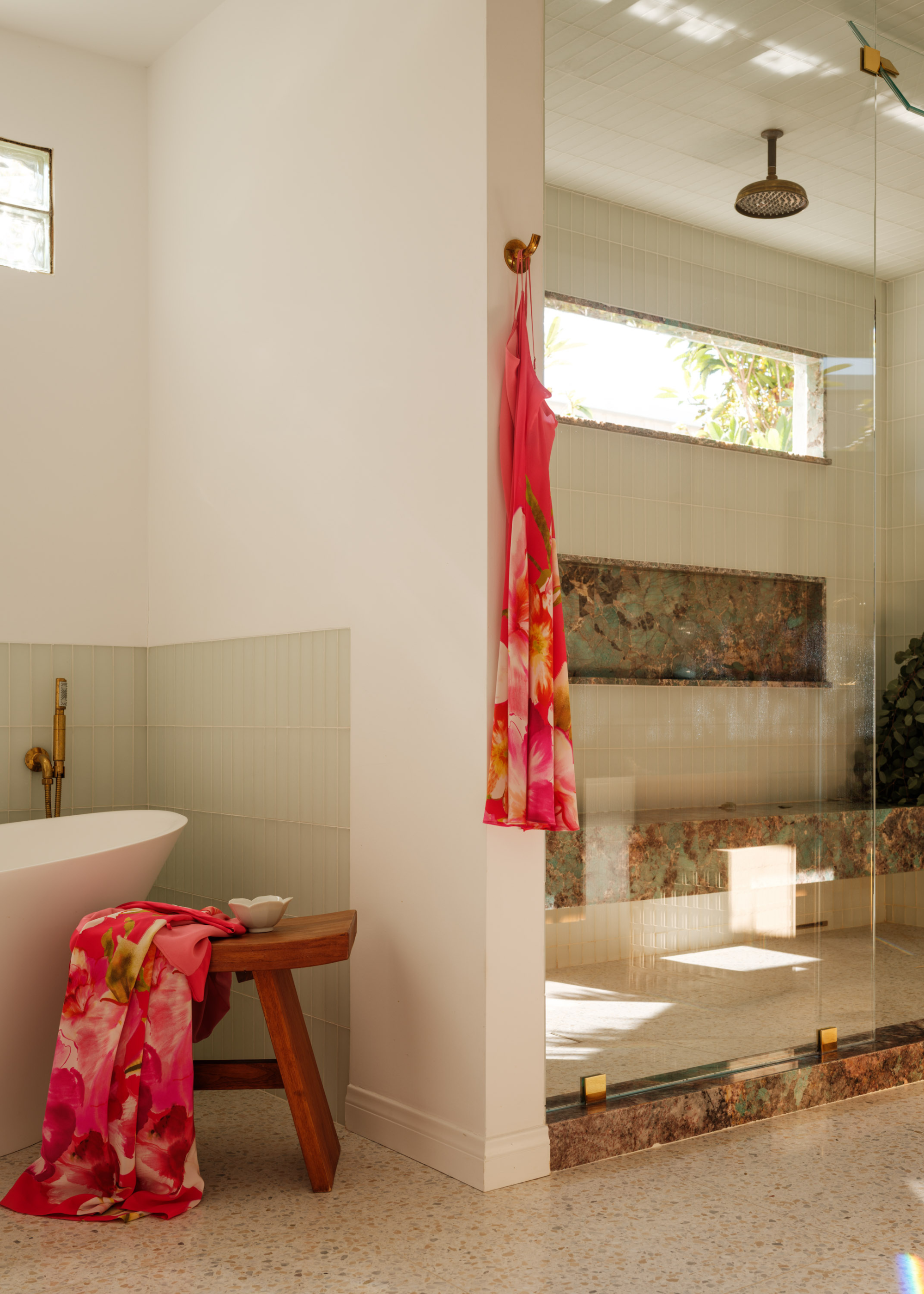 A bathroom with a shower space and a bath tub