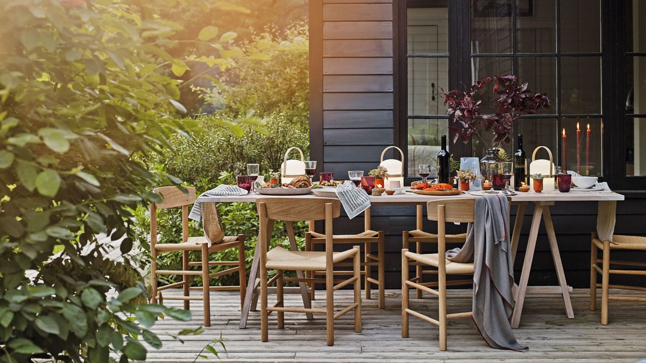 Decorated dining table and chairs on patio area outside of house