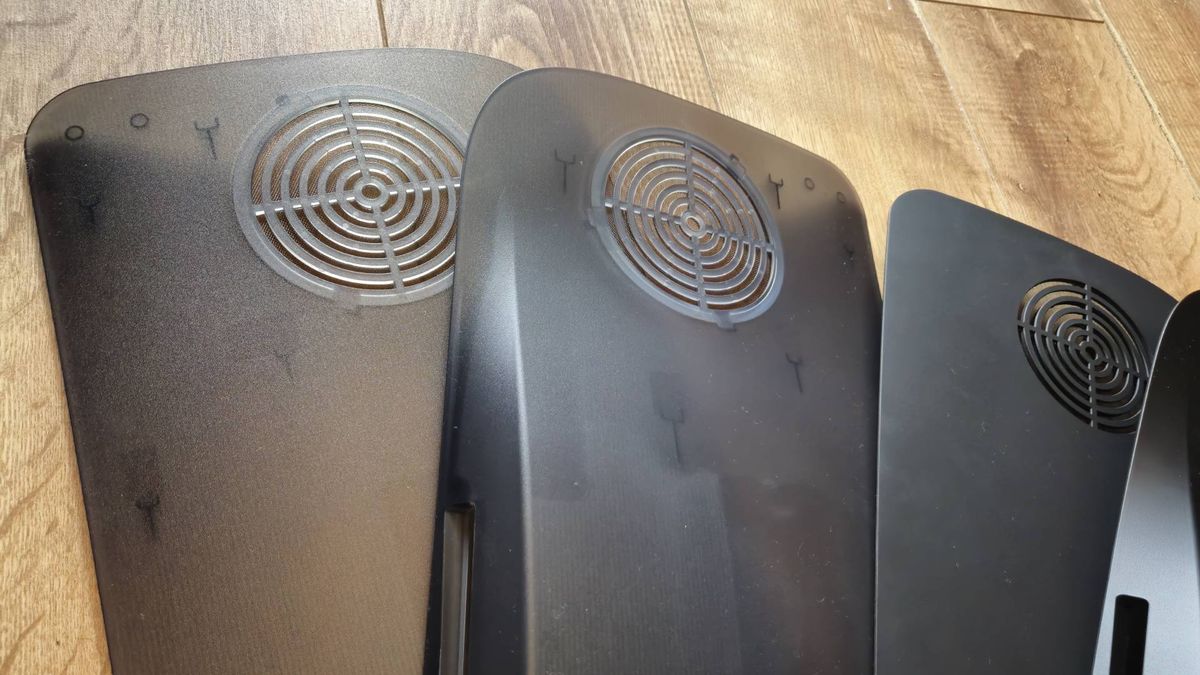 Photos of the 'Smoke Black' and Matte Black PS5 Darkplate console covers.
