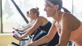 Image of women on exercise bikes in group workout