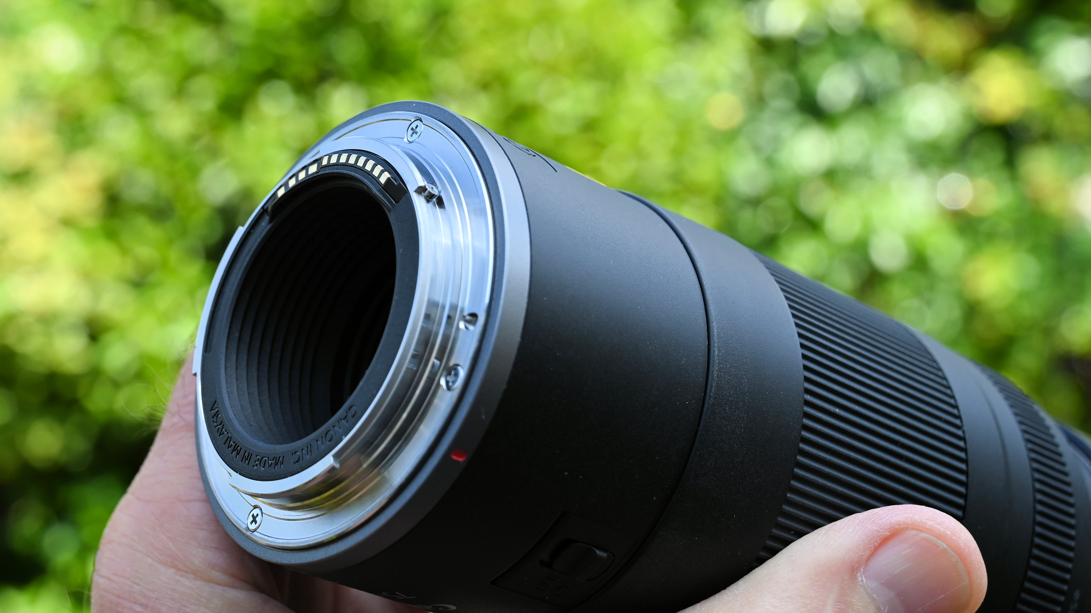 Canon RF 75-300mm f/4-5.6 product shot held in hand