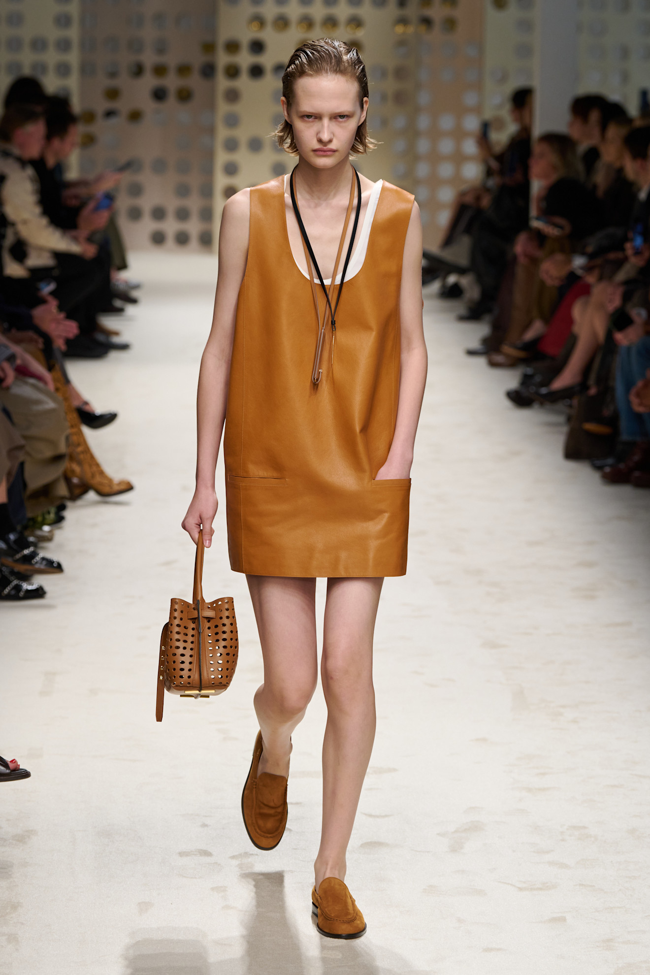 Tods runway model wearing backless loafers.