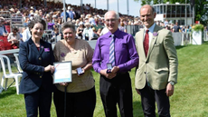 Fence judge Pauline McKay, pictured second from the left, collecting her award at Badminton Horse Trials with her husband John