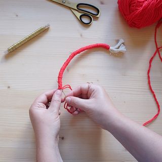 ainbow macrame bunting assembly with darning needle and scissors