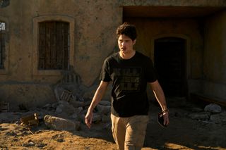 Noah Centineo as Owen Hendricks looking bloodied and battered