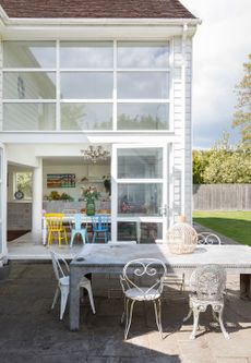 Bi-fold doors leading to a terrace on a modern two-storey extension