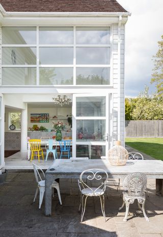 Exterior of a modern two-storey extension with sliding doors leading out to a terrace