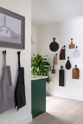 white kitchen with hanging chopping boards by LH. Designs