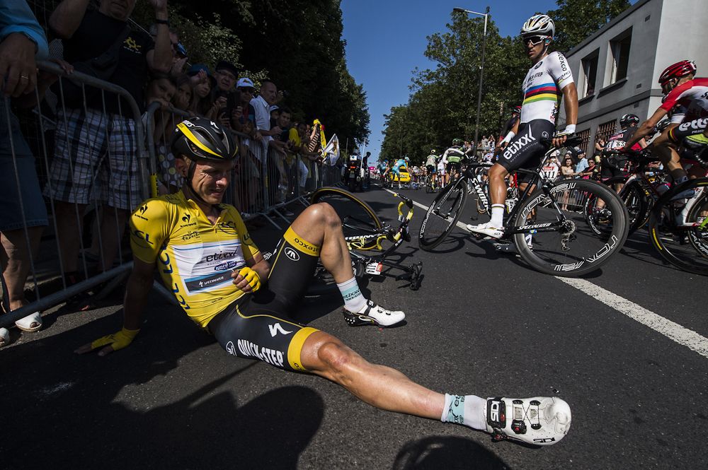 Tony martin lays against the barriers after crashing during stage 6.