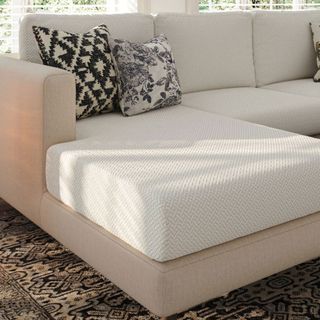 Cream l-shaped sofa with cream sofa cover