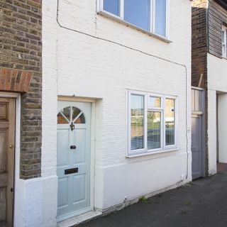 house exterior with white wall and white door