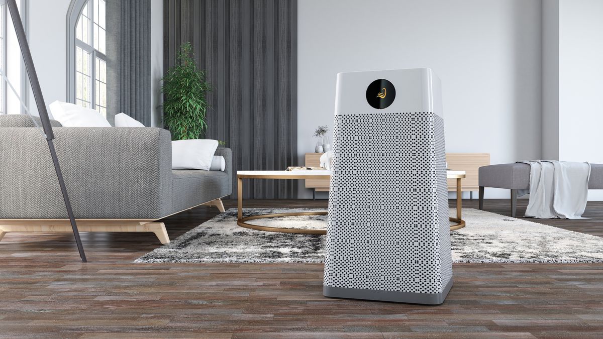 An air purifier standing in the middle of a living room